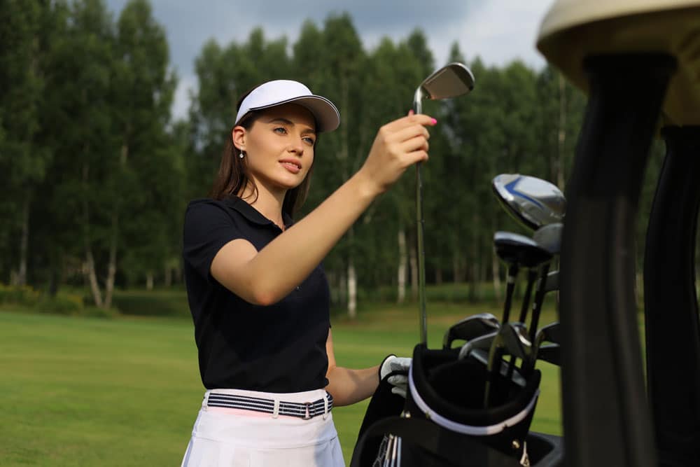 Image of a woman choosing a golf club
